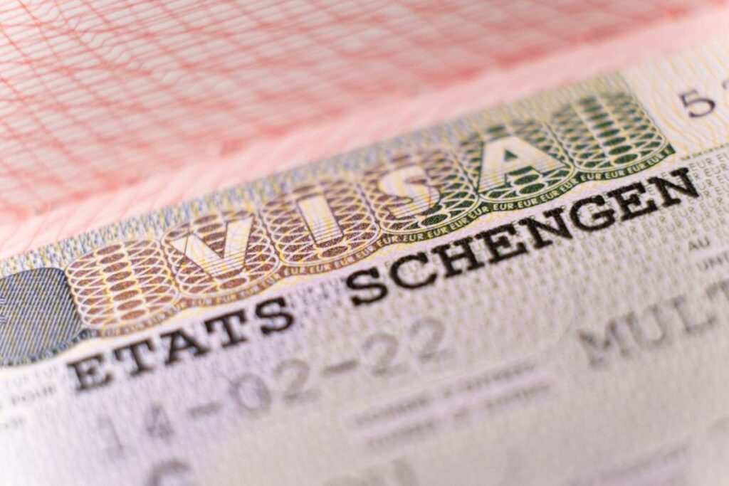 Macro close up of Schengen visa sticker in passport showing approval details for Europe work permit from India application process