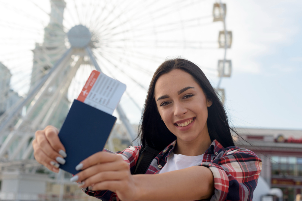 Happy traveler holding passport and boarding pass after receiving tourist visa from India approval ready to explore international destinations