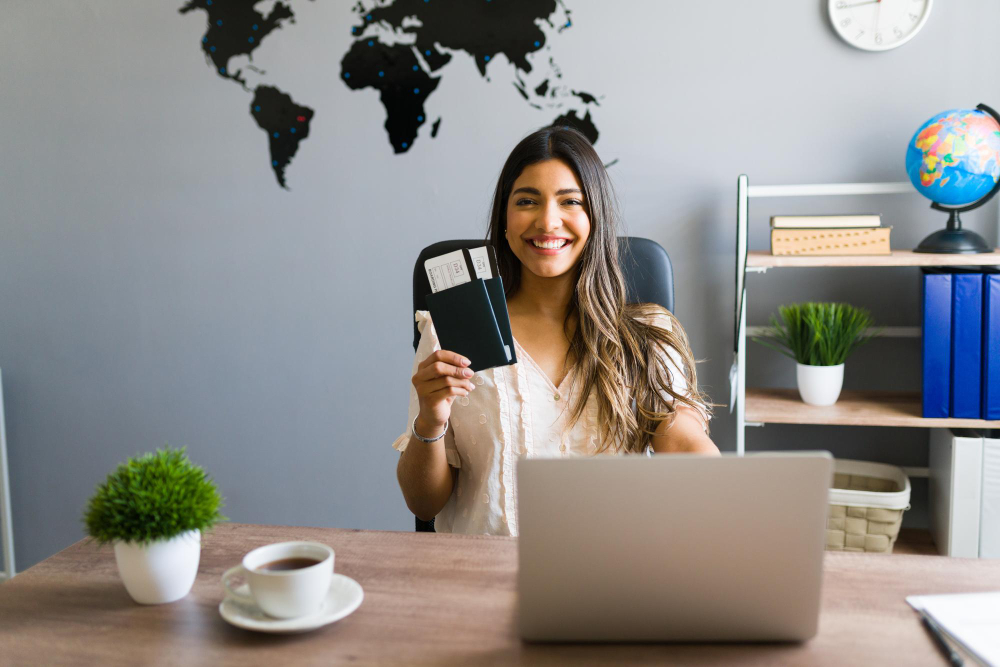 Woman working on laptop holding passport and tickets while applying online for tourist visa from India and planning international travel